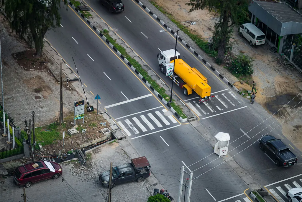 Fuel tanker truck travelling with traffic on a Lagos road